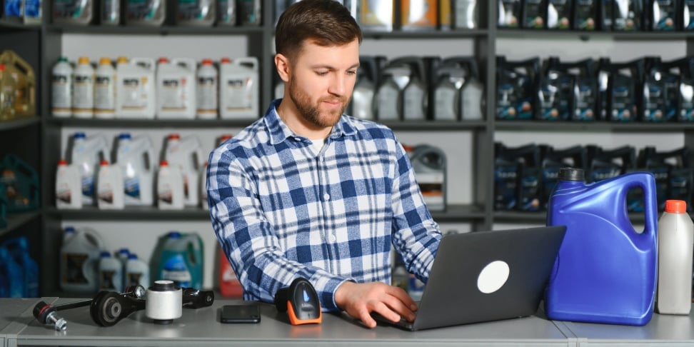 Parts dealer at a countertop with a laptop