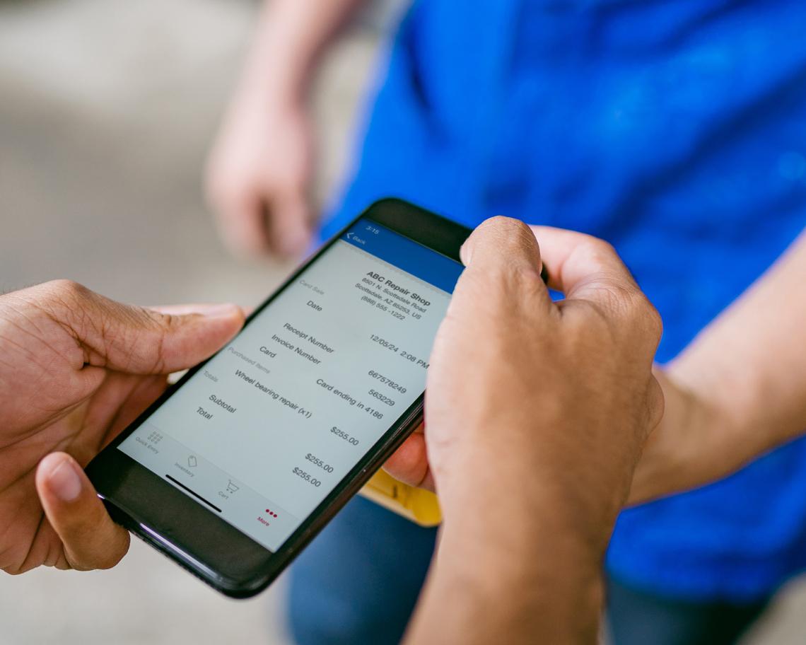 A customer looks over a digital invoice on a phone