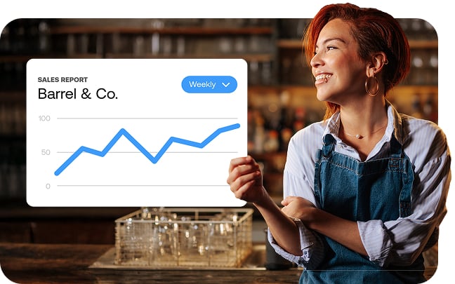 An example of a sales report next to a business owner in her bar.