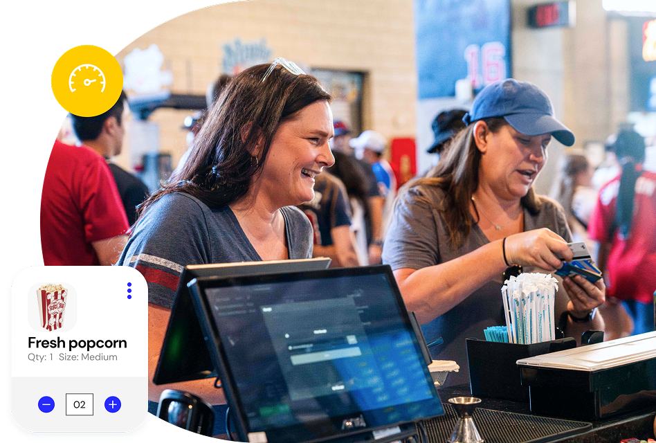 Group of fans in line at a stadium concession stand. A popup point of sale UI shows them being rung up for a Fresh popcorn on a countertop venue POS system.