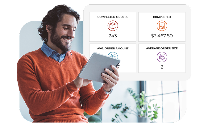 A business owner smiling while analyzing his POS data dashboard.