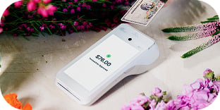 A handheld terminal displays a completed transaction.
