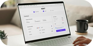 A person clicks on a laptop that displays an online checkout page.