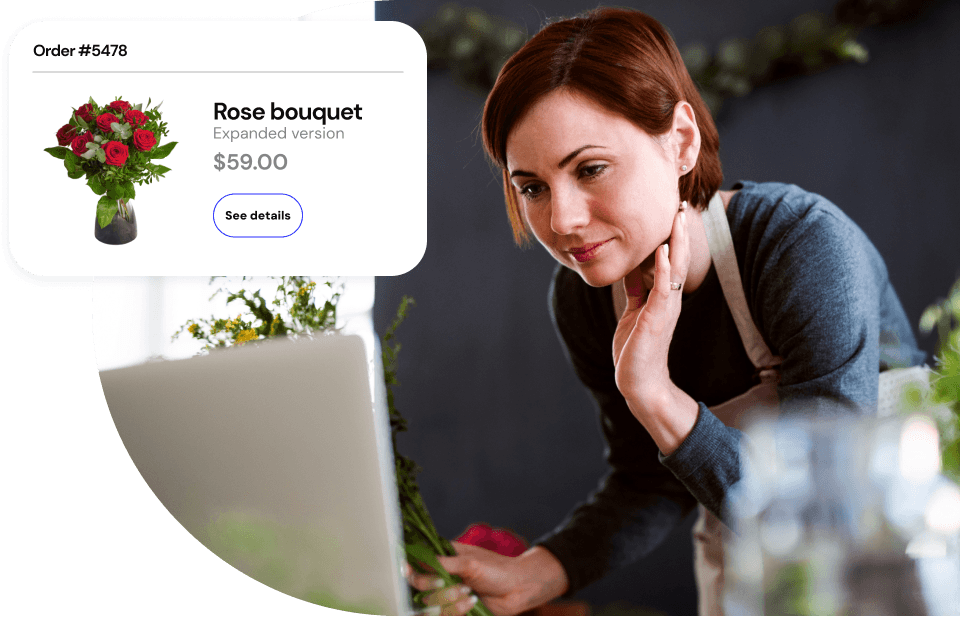 A flowershop owner using their online payments platform to prepare an order.