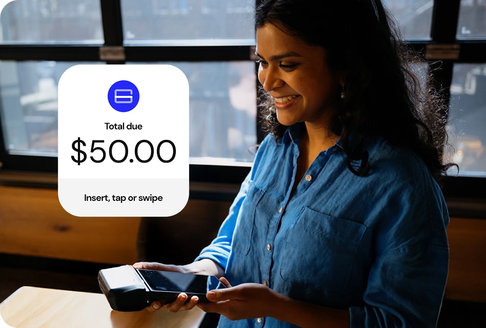 Woman smiling while holding out a mobile payment terminal. A screen shows “Total due $50” with the option to insert, tap or swipe