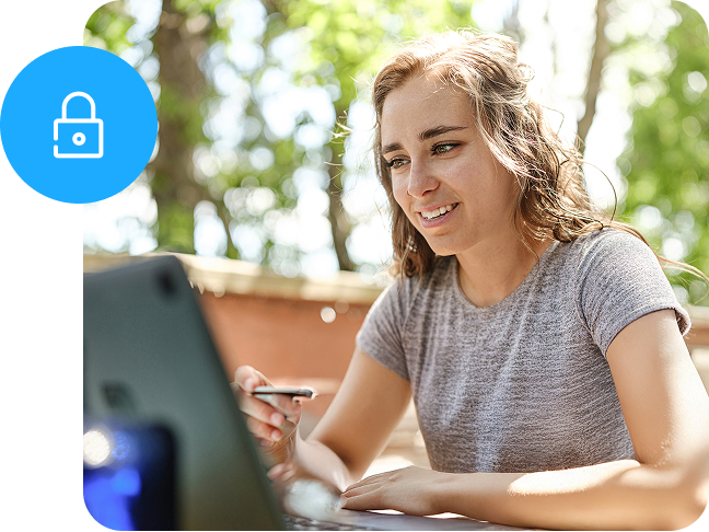 A woman sitting at an open laptop smiles as a small circle graphic with a lock inside overlays the scene.