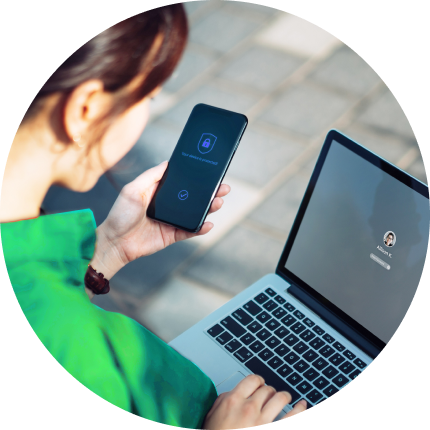 woman on laptop and phone