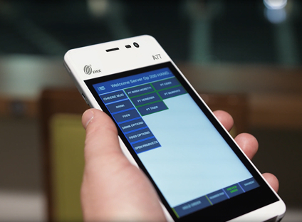 Closeup shot of a server’s hand holding a mobile PAX A77 tablet featuring a food ordering screen