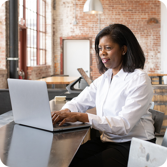 Woman at desk working on laptop