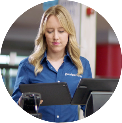Circular image of retail worker in Global Payments shirt operating point of sale terminal system in Mercedes-Benz Stadium