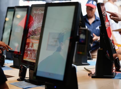 A series of kiosks are set up in Truist Park in Atlanta to allow baseball fans to self-serve.