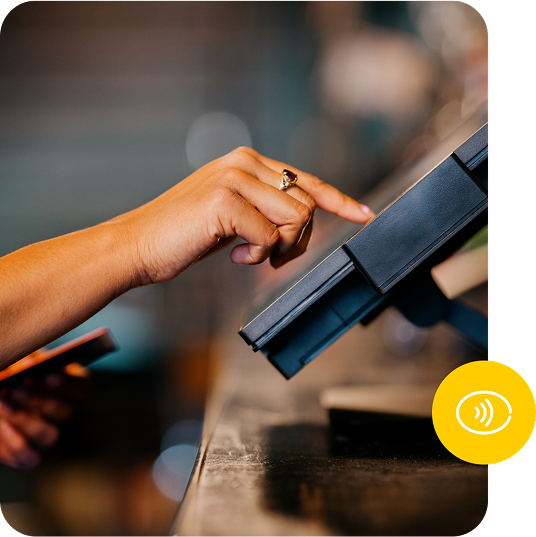 A person taps on a terminal screen with their finger.