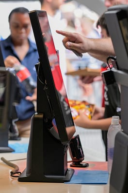 Fans make a payment from a self-service kiosk.