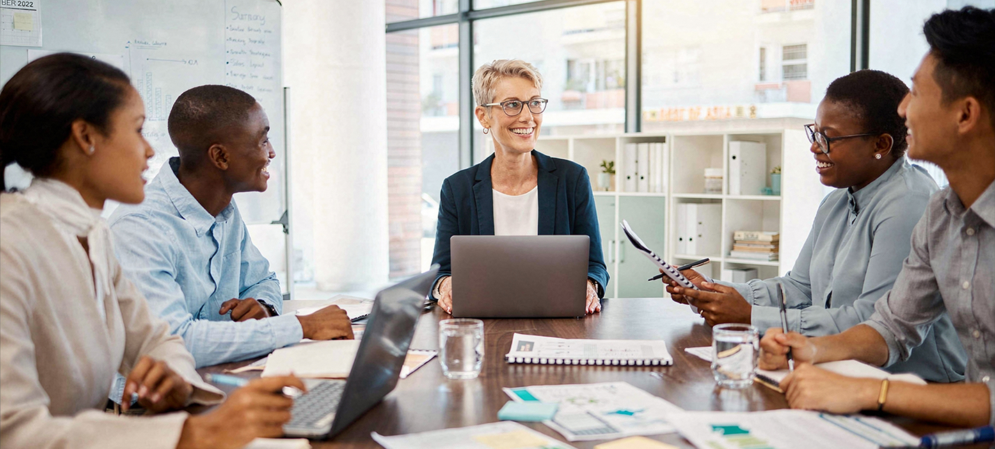 Several business colleagues sitting at a table having a meeting. 
