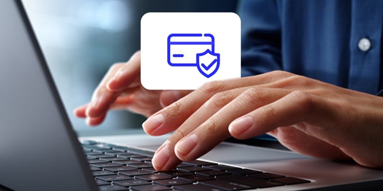 A person using a laptop to make a secure card payment.