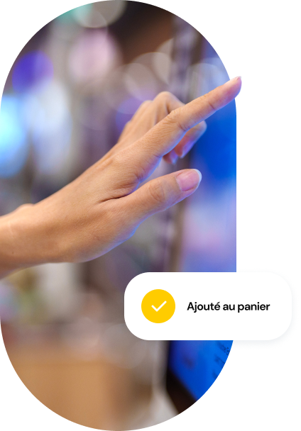 A close-up of a person’s hand making a selection on a food kiosk with a UI call-out that says “Added to cart” at the bottom of the image.