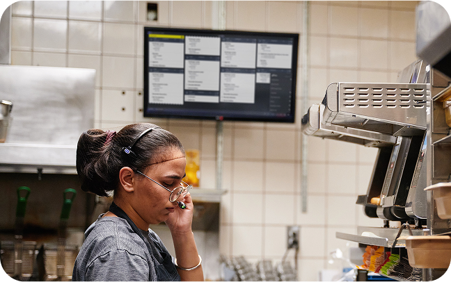 Front of house restaurant worker operates a countertop point of sale.