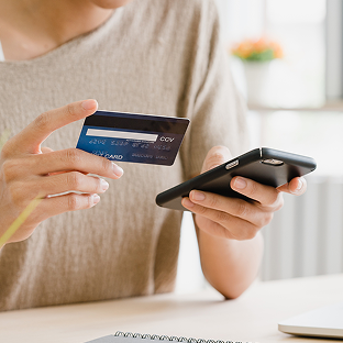 A customer makes a card payment on a mobile phone.