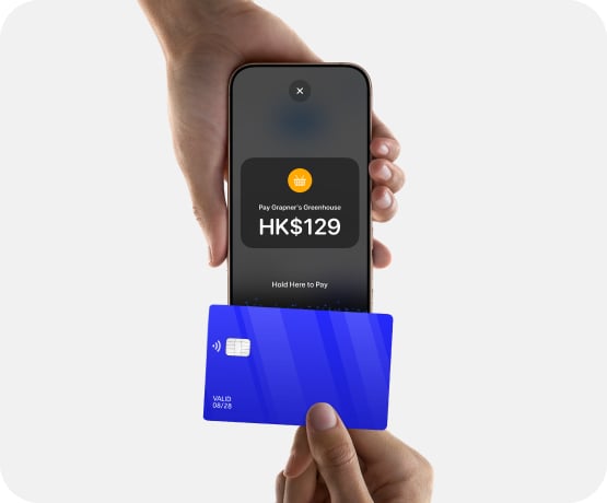 Closeup of person paying with card to iPhone