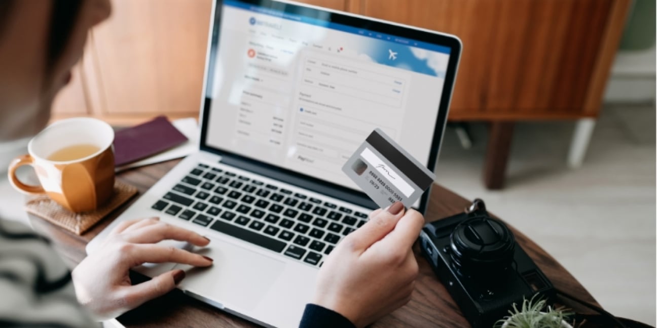 Close up of woman making credit card payment on laptop