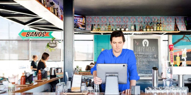 Small business owner looking at menu options
