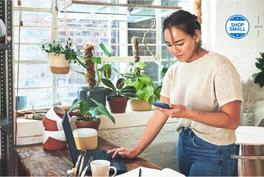 person at laptop on counter reviewing a payment being processes
