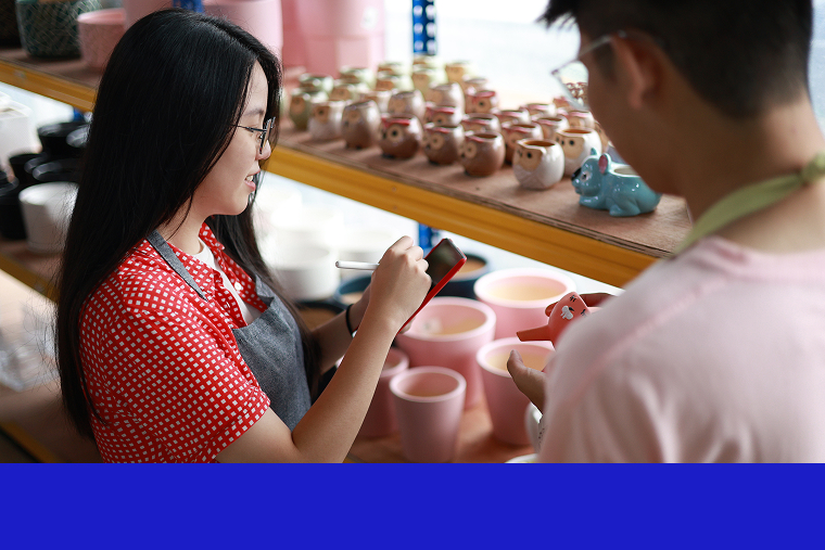 Two people working in a retail shop take inventory.
