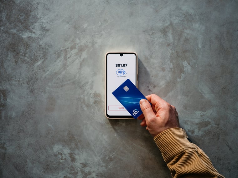 Contactless payment transaction using mobile phone as terminal and blue card tapped against screen