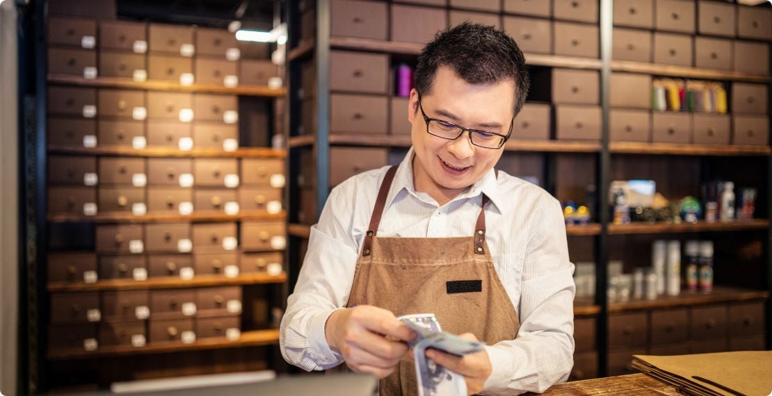Small business owner counting cash