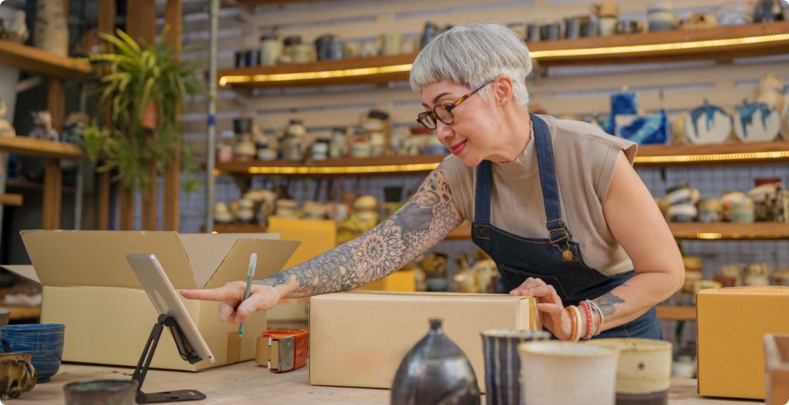 Older small business woman using a tablet