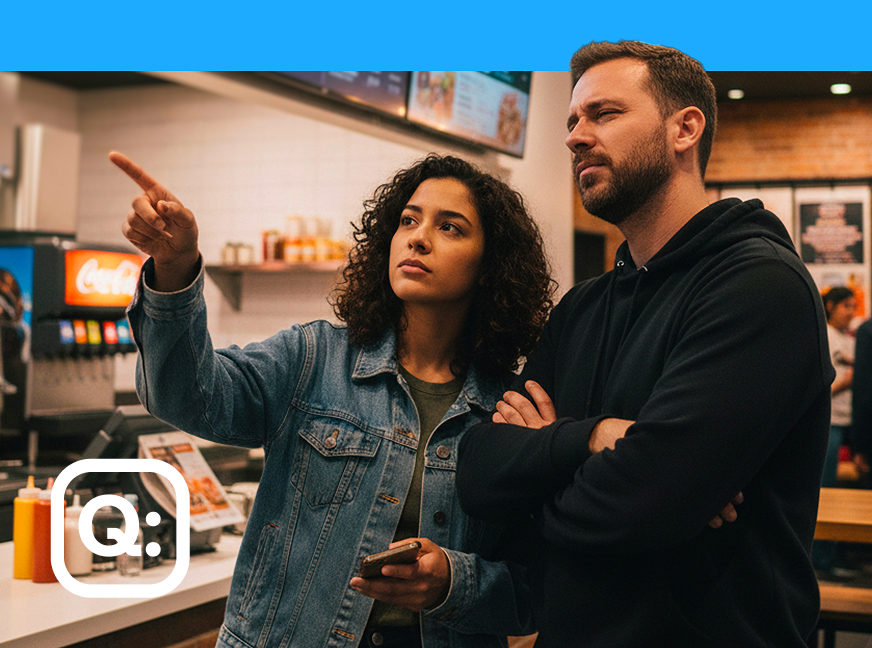 Consumers look at menu board as they contemplate their orders