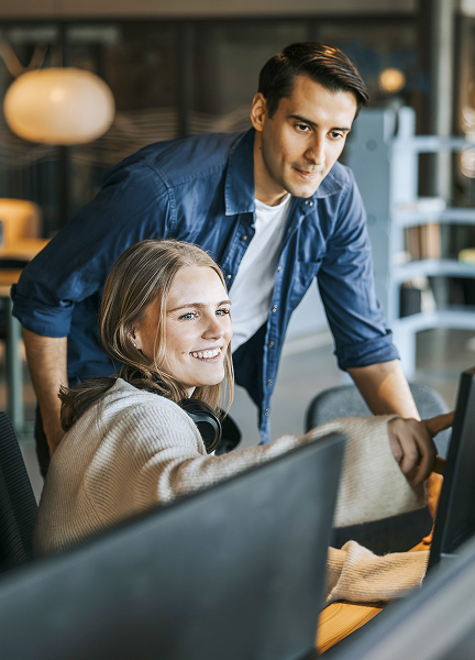 Developer points out something on their computer to their coworker.