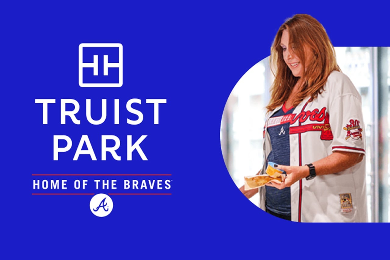 Image with Truist Park logo on left-hand side and smiling baseball fan on right-hand side