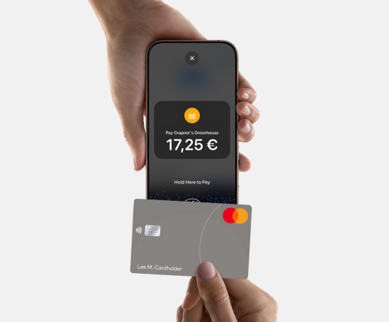 Close up of person using card to complete contactless payment to handheld POS device