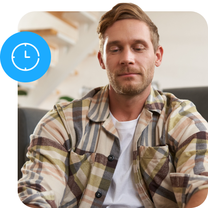 A man in a checkered shirt looking down with a blue clock icon nearby.