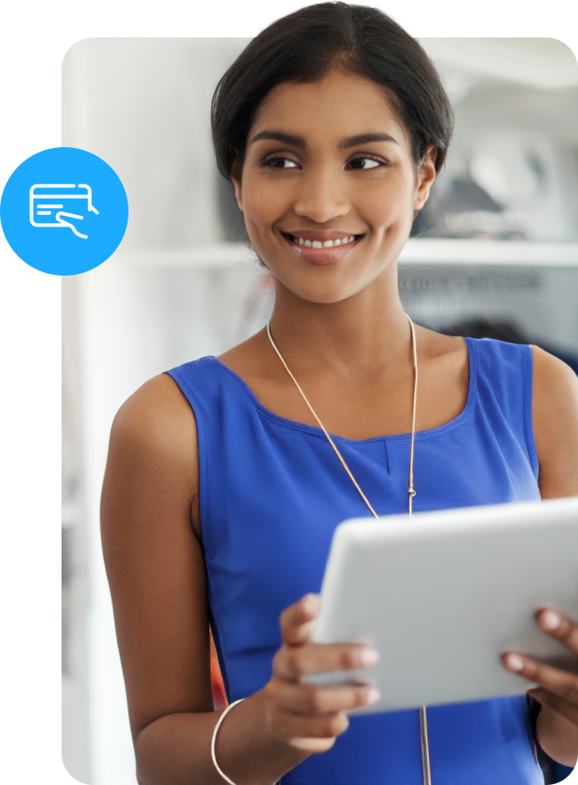 Woman working in retail environment looking at tablet and smiling