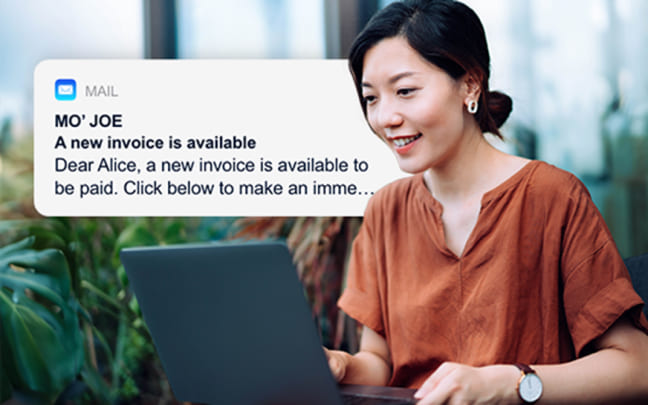 Woman on a laptop with an email notification popup for a new invoice available.