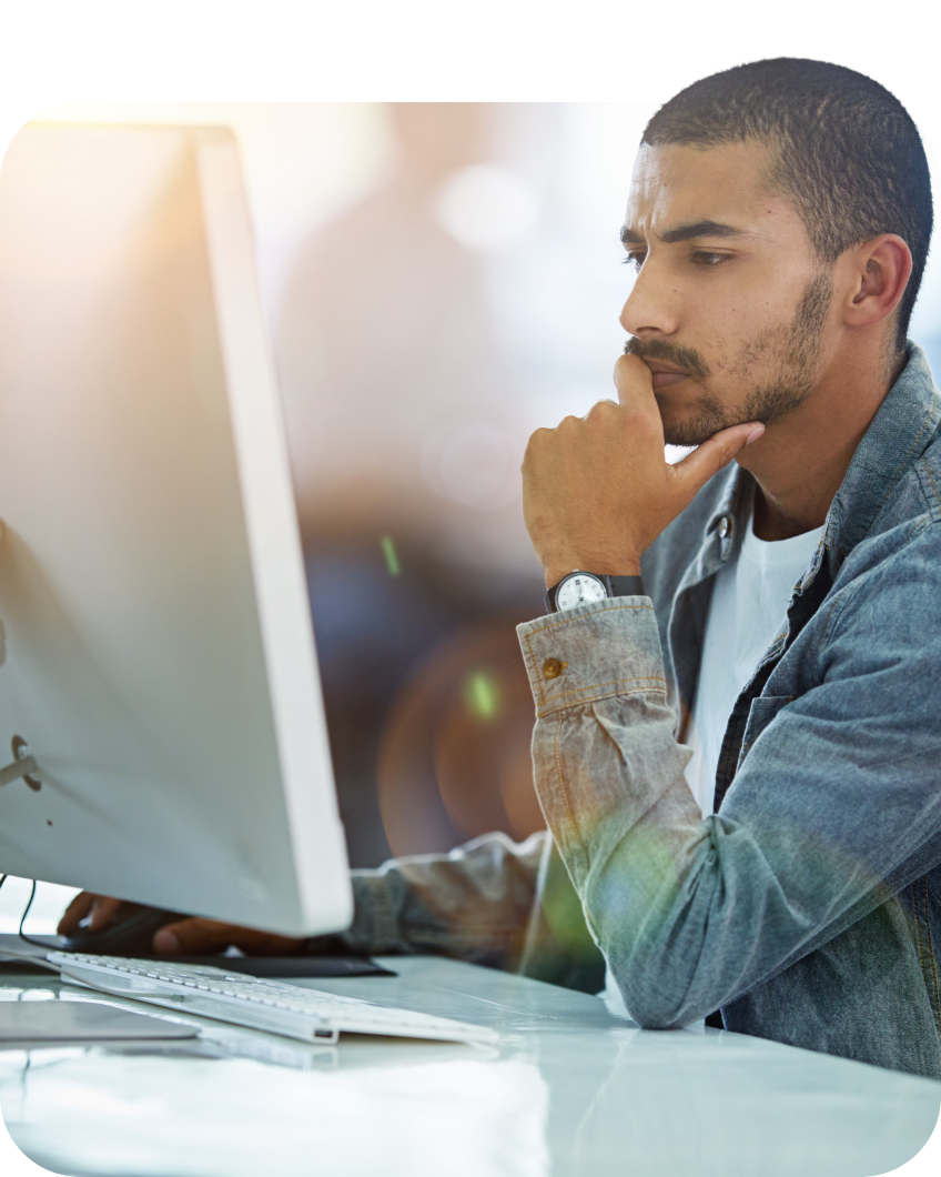 Man sitting at a computer and focusing on the screen