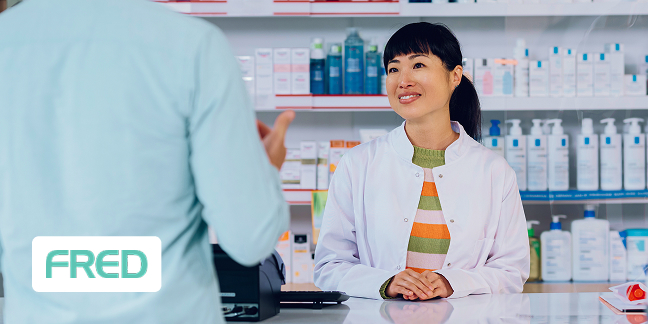 Woman in a medical supply store talking to a customer. Fred logo on the screen.