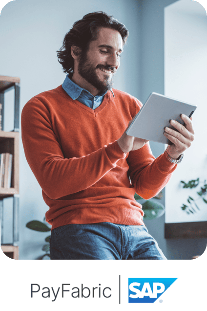 Man using a digital tablet above PayFabric and SAP logos.