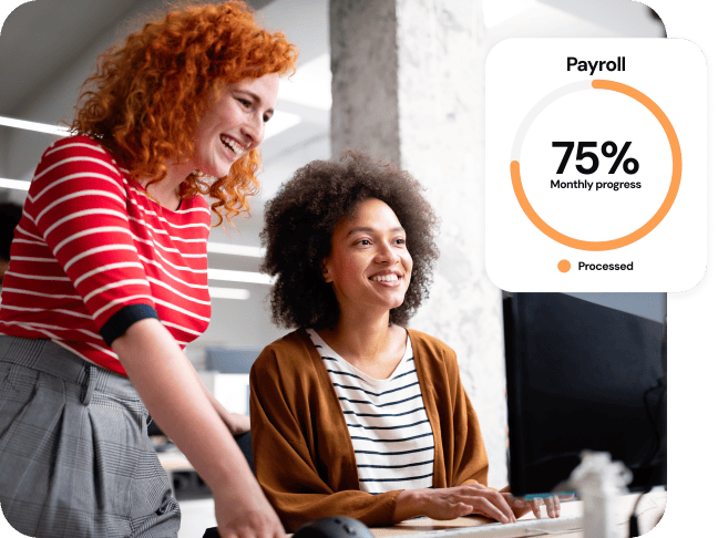 Two women using a computer overlaid with a 75% payroll processed graphic.