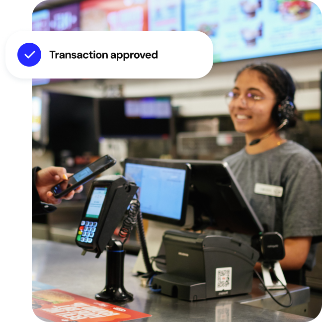 Customer using contact payment from mobile phone at quick service restaurant