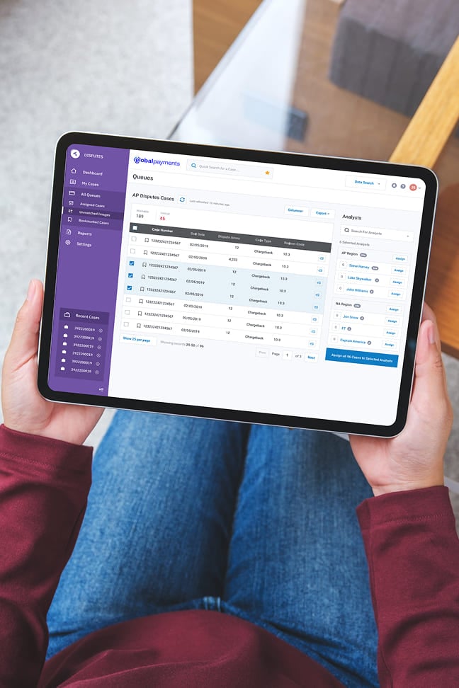 Hands holding a tablet displaying a Global Payments dispute management software dashboard.