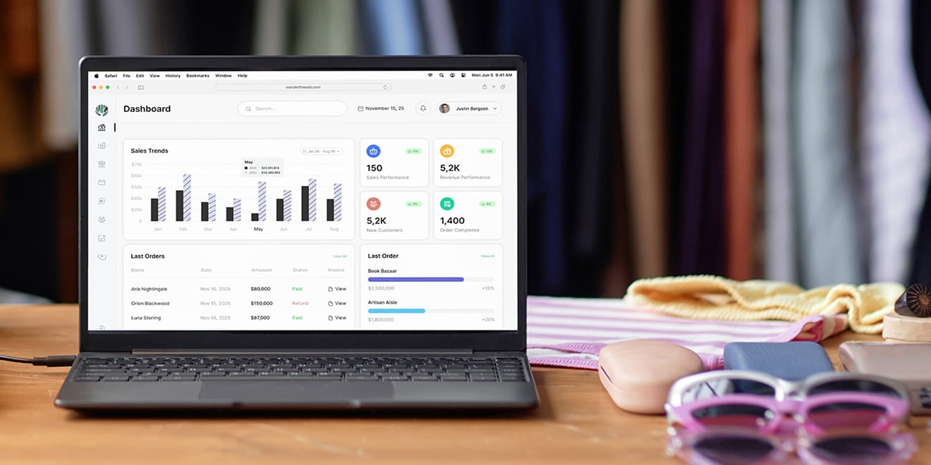 Open laptop displaying sales trends analytics on a desk with accessories nearby.