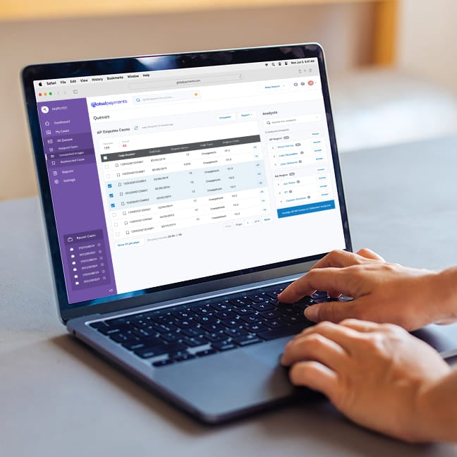 Person typing on a laptop screen showing business reporting metrics and graphs.