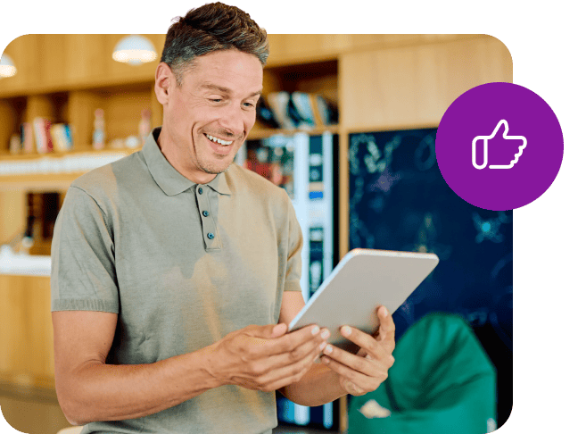 Smiling man holding a tablet with a purple thumbs-up icon overlay