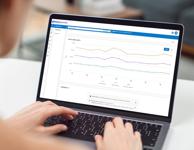 Close-up of a person using a laptop to review financial transaction reports and charts.