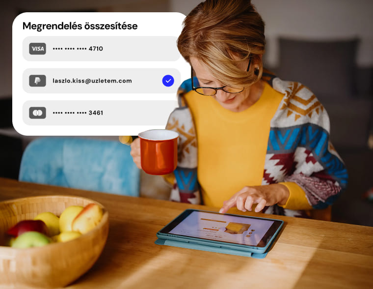 Nő egy tabletet használ, rajta egy rendelésösszesítő fizetési grafikával.