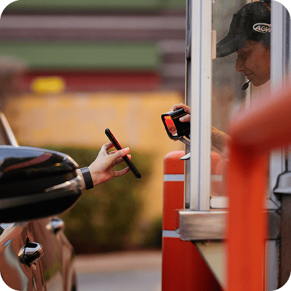 A customer receiving her order through her car window.