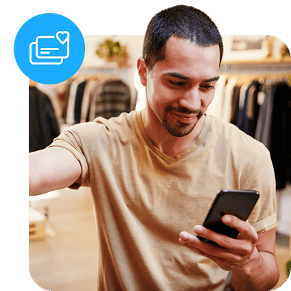 A customer looking at his mobile phone while shopping inside a retail store